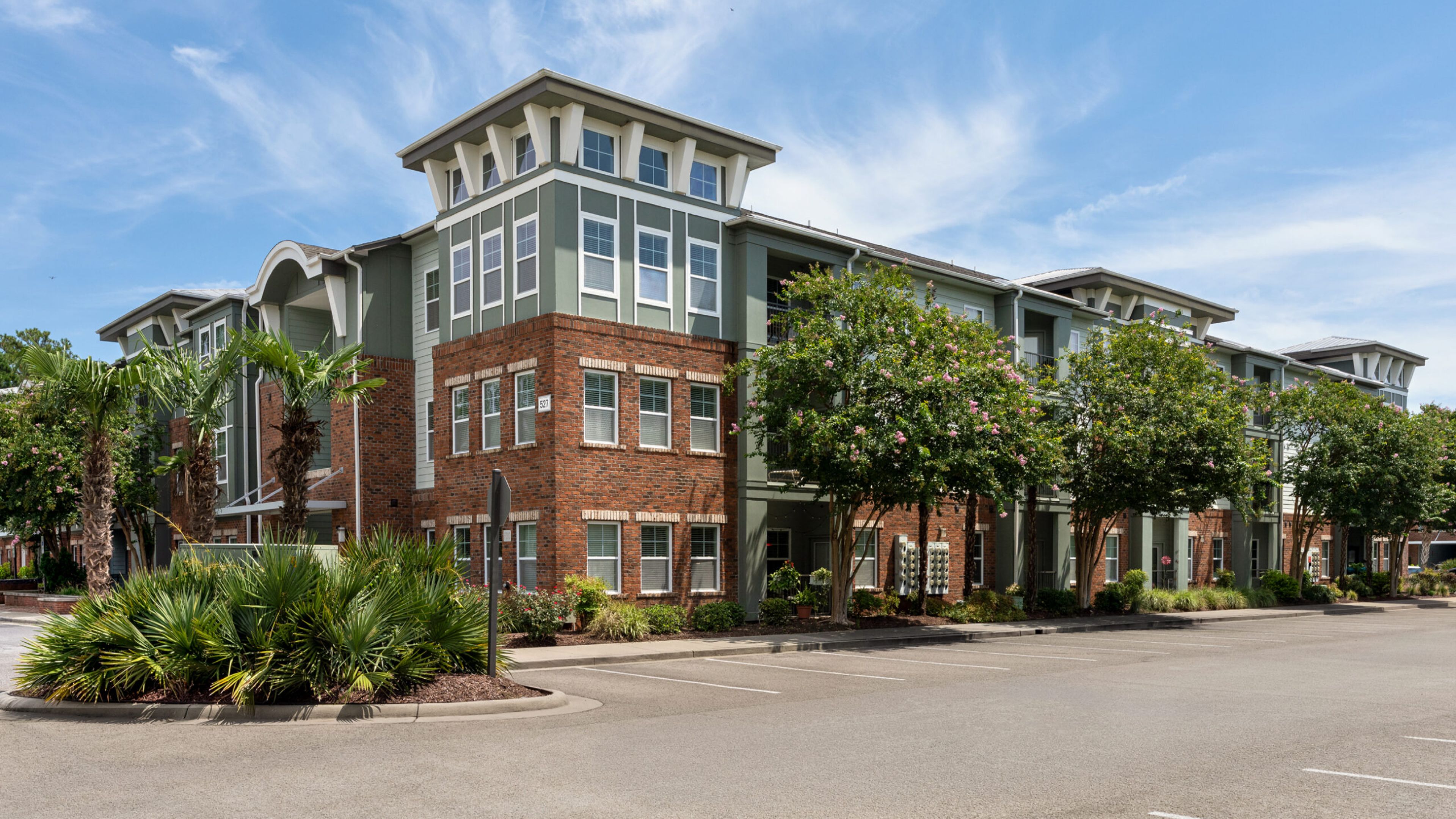 Hawthorne at the Station outdoor lawn with hammocks and tropical landscaping