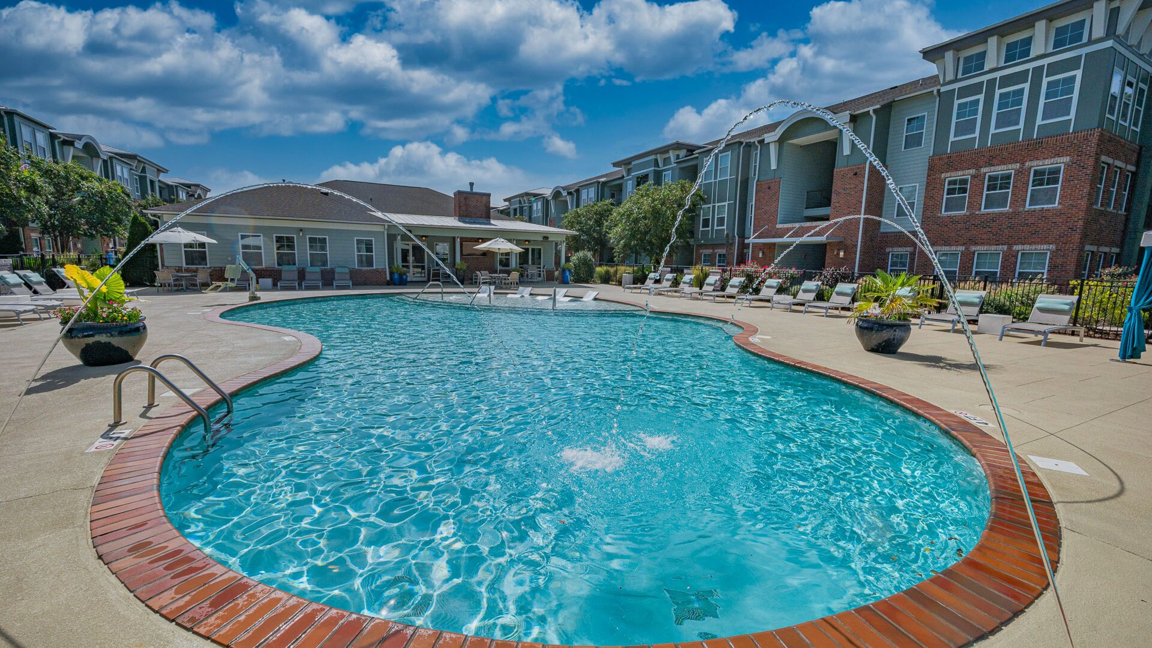 Hawthorne at the Station luxury outdoor pool with in-pool lounge chairs and surrounding seating
